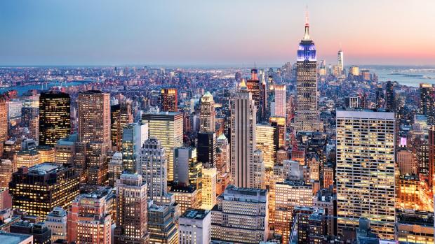 NYC skyline lit up at twilight