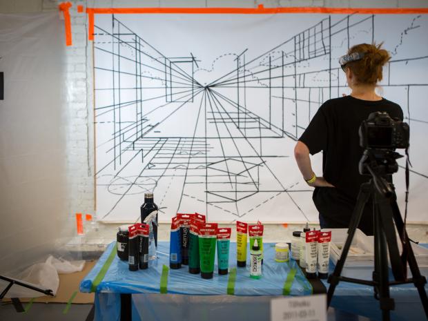 student looking at large scale perspective drawing
