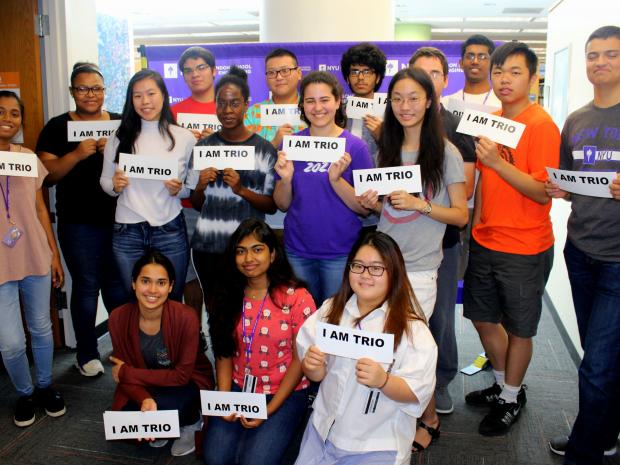 group of diverse students holding signs saying "I am TRIO"