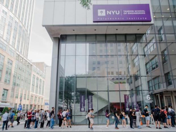students outside modern campus building