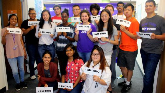 group of diverse students holding signs saying "I am TRIO"