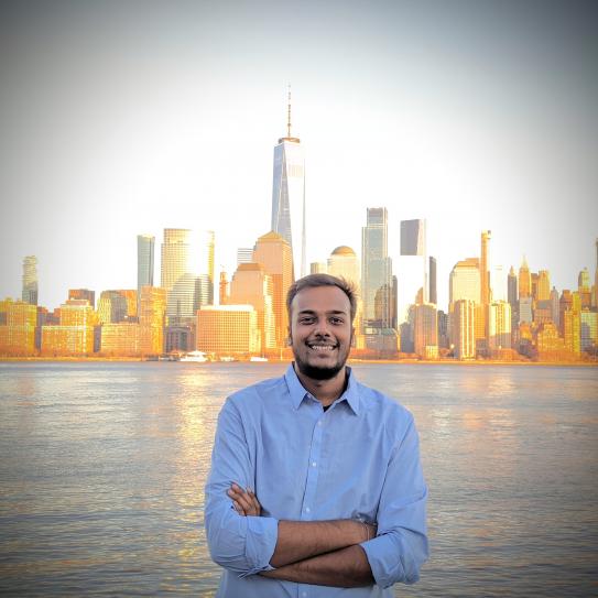 Yash Shah standing in front of city skyline