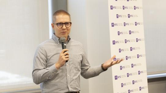 Professor holding a microphone and giving a speech