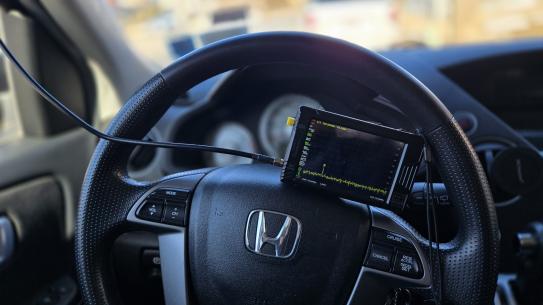 tinySA spectrum analyzer installed on a steering wheel