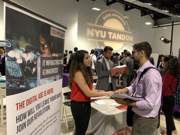 Employer talking to a student at Tandon Career Fair