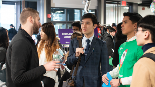 Students speaking to employers at our career fair Students speaking to employers at our career fair