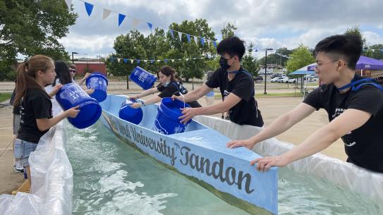 Team testing the flotation of a canoe