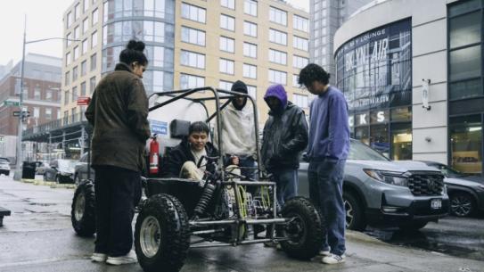 Students around the car in the city